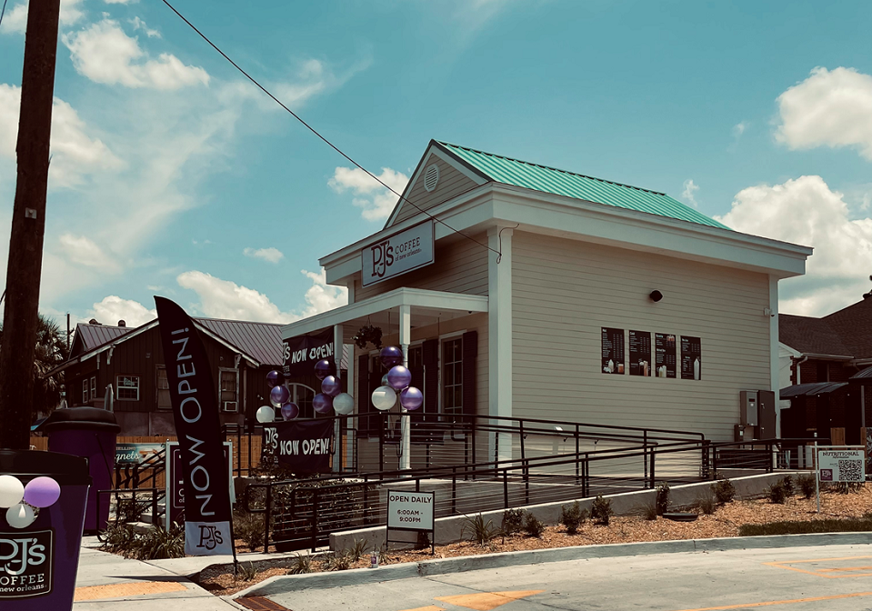 The grand opening at PJ's Coffee franchisee Aubry Miller's location. Balloons and banners are set up outside of the coffee shop entrance and driveway.